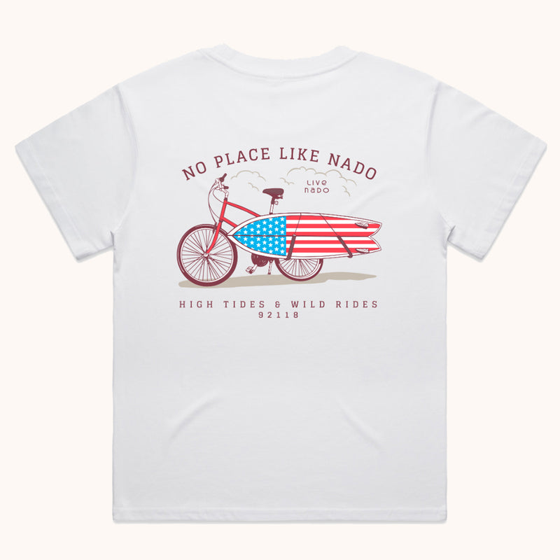 white soft 100% cotton no place like nado tshirt that has a bicycle design with an american flag surfboard attached