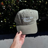 light olive color dad hat with no place like nado embroidered in it