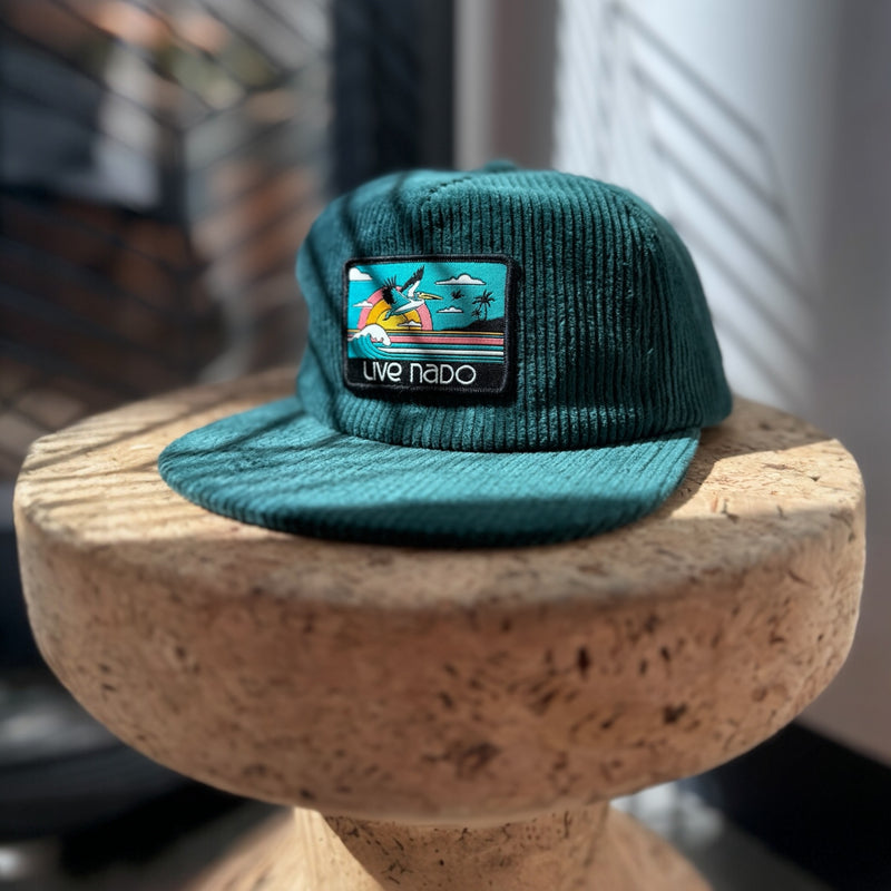 Teal corduroy flat brim baseball cap and also called a surf cap